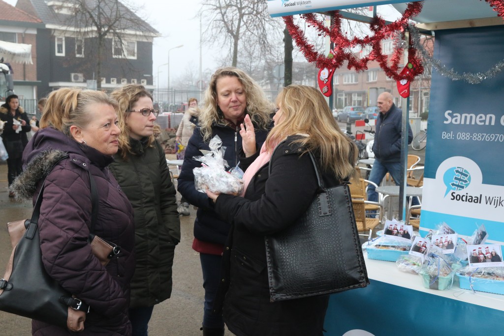 Sociale Wijkteam deelt kerststol uit op de Weekmarkt